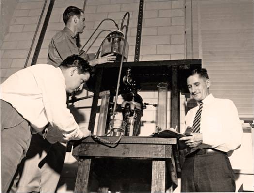 Dr. George Fancher, left, supervises graduate students in the Drilling Fluids Research Lab, 1950s.