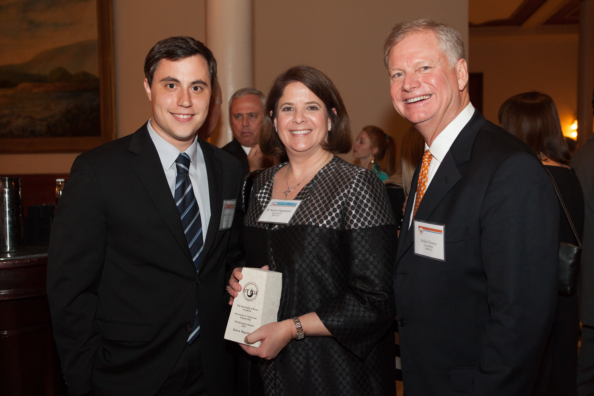Alumna Karen Hagedorn holding award and smiling with family.