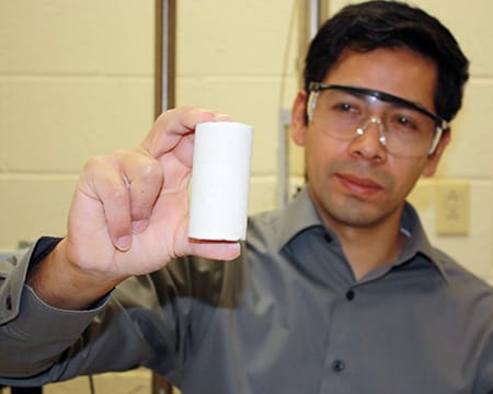 Dr. Espinoza holds up a core sample.