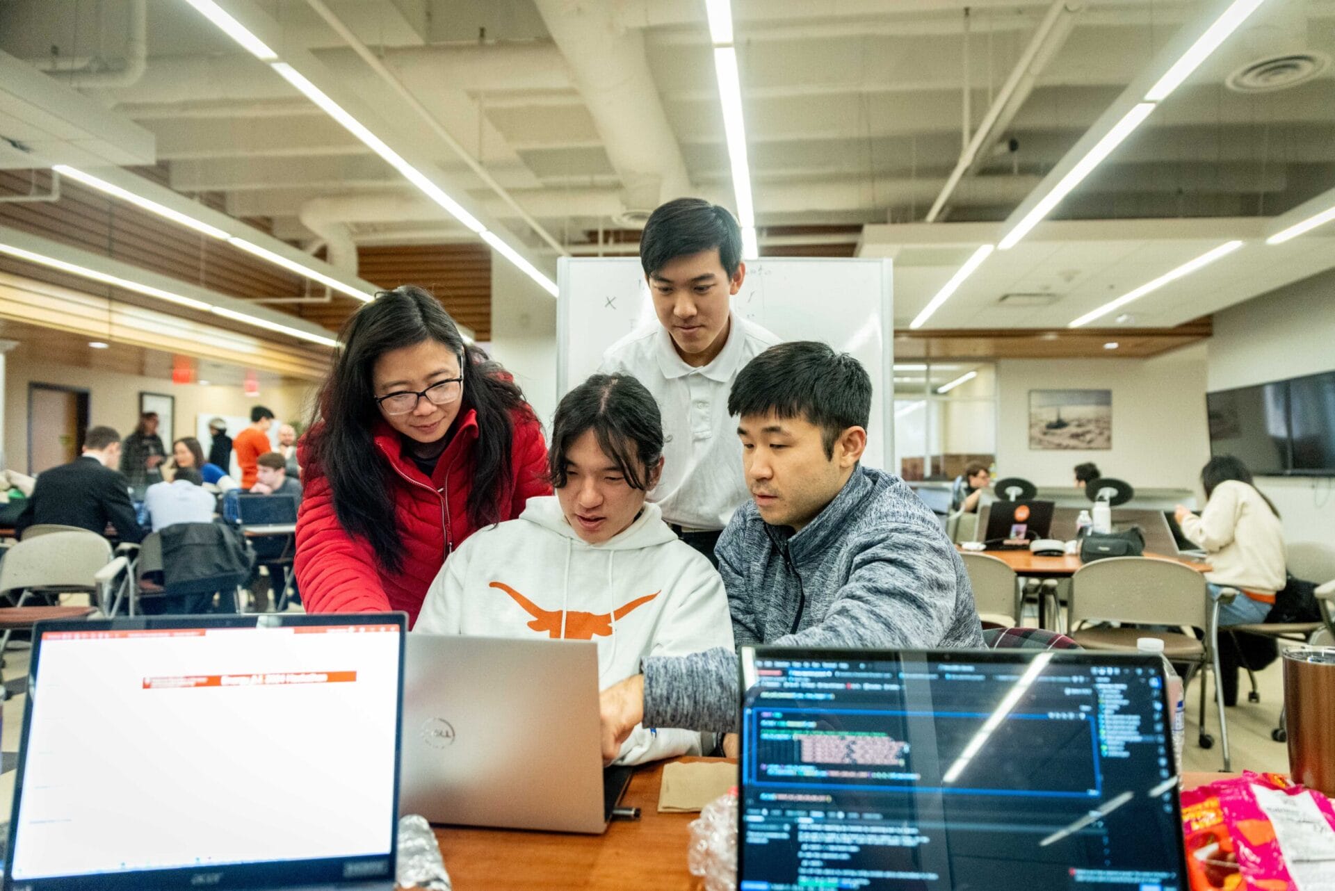 Students gathered around a laptop