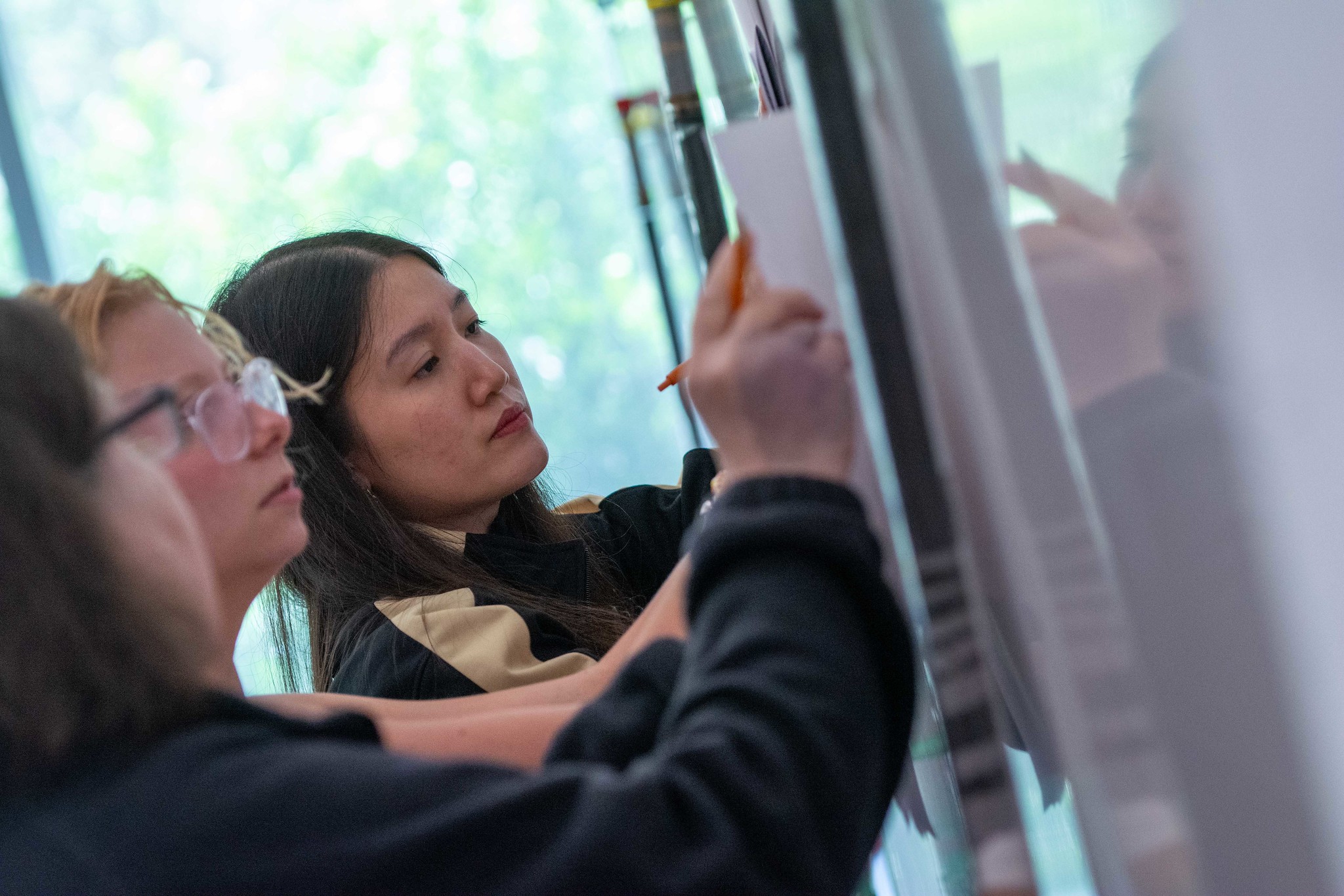 Participants gathered around whiteboards writing during Energy Science and Technology Institute event.