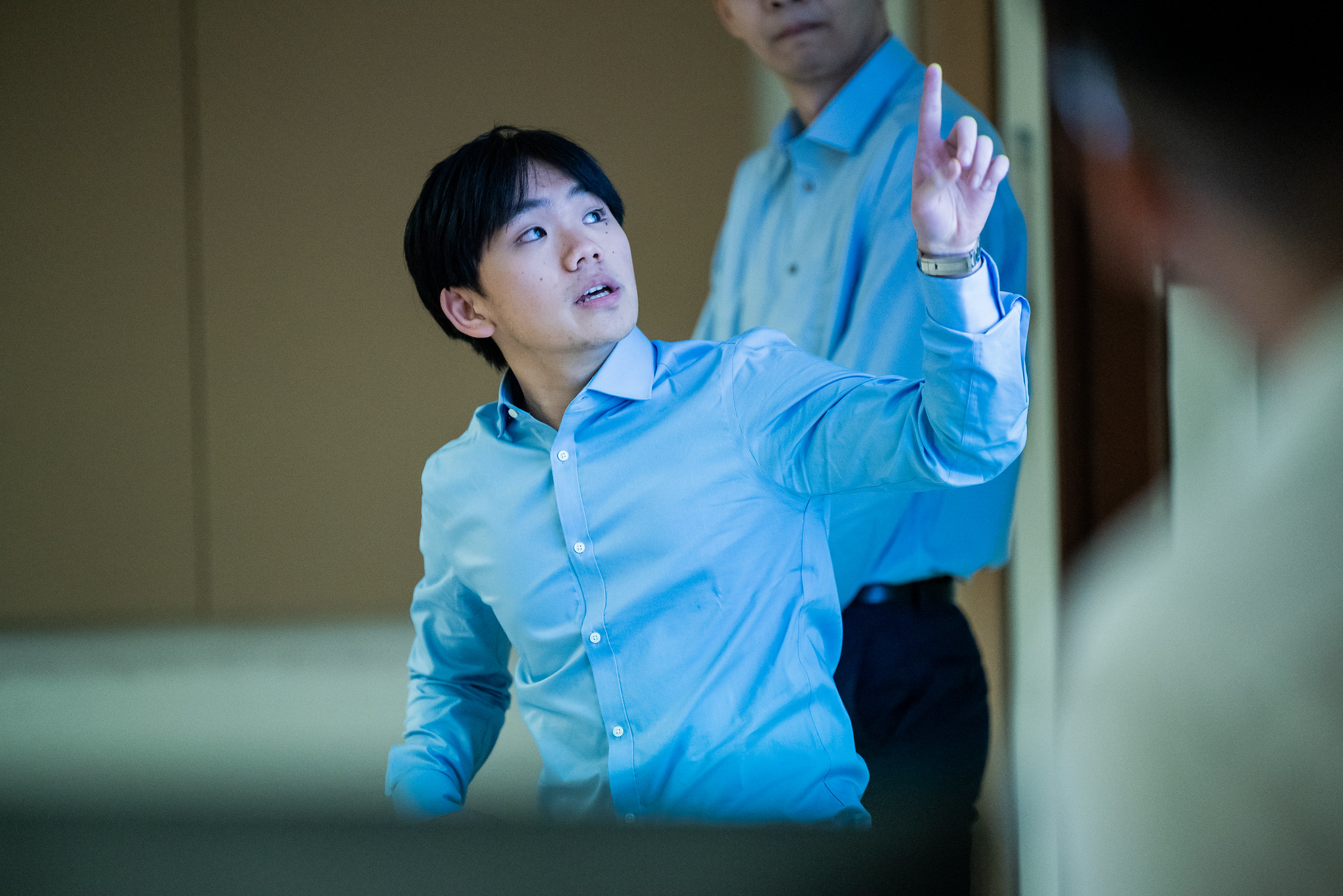 PGE student pointing at large projector screen during prrsentation.