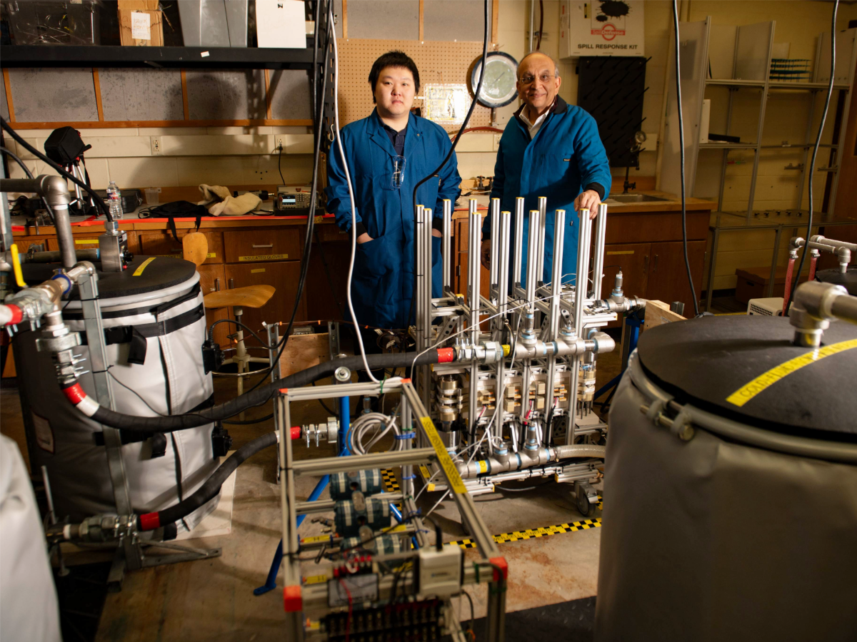 Mukul Sharma smiling in his research lab with graduate student researcher.