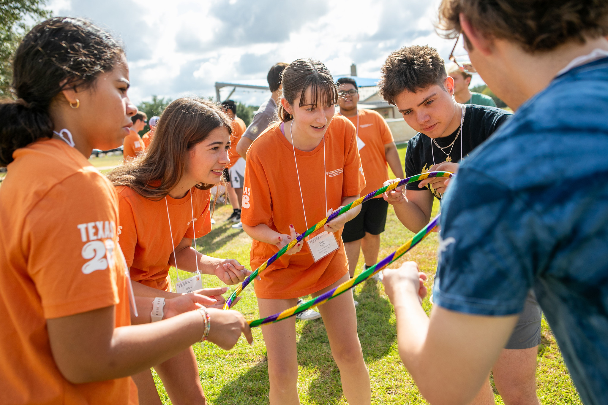 Group of PGE students playing game involving them holding a hula hoop.