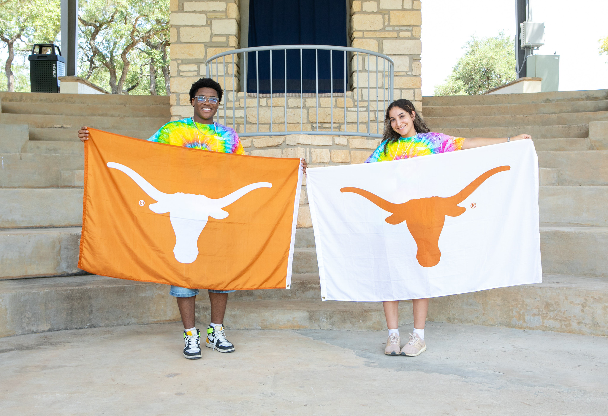PGE students holding up UT Longhorn flags with UT Austin logo.