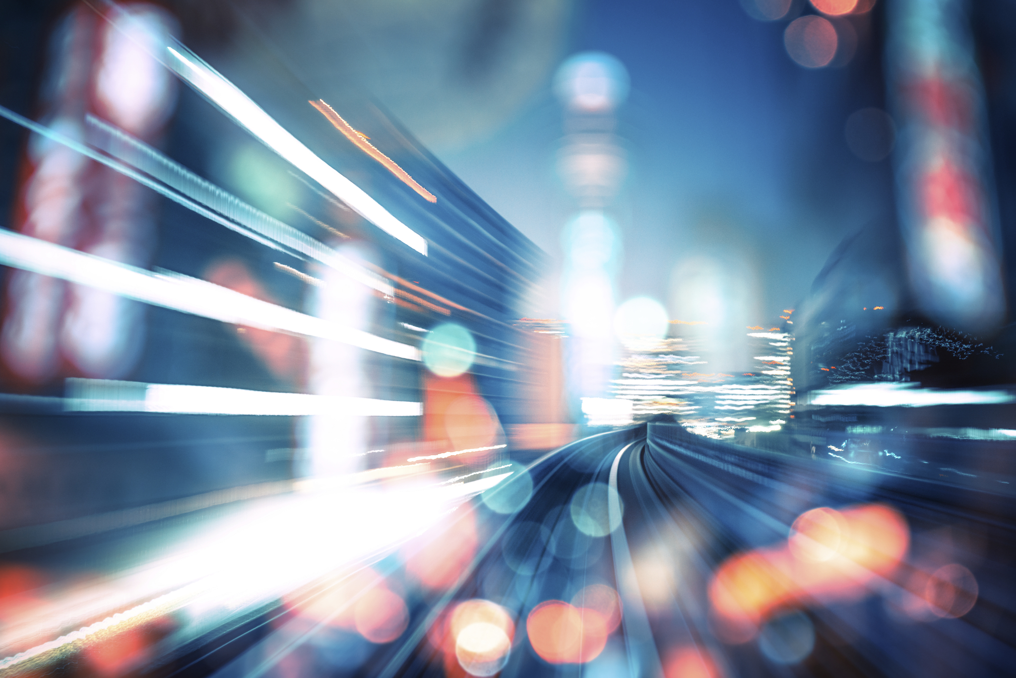 Blurred lights from cars and city buildings from the road.
